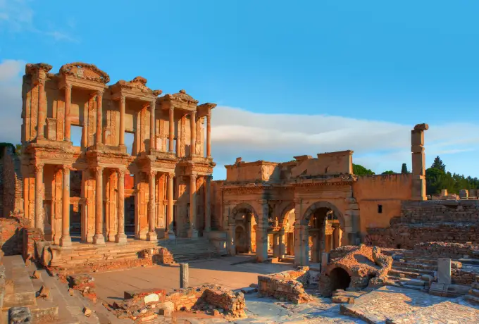 The Library of Celsus at Ephesus in warm amber sunrise light.